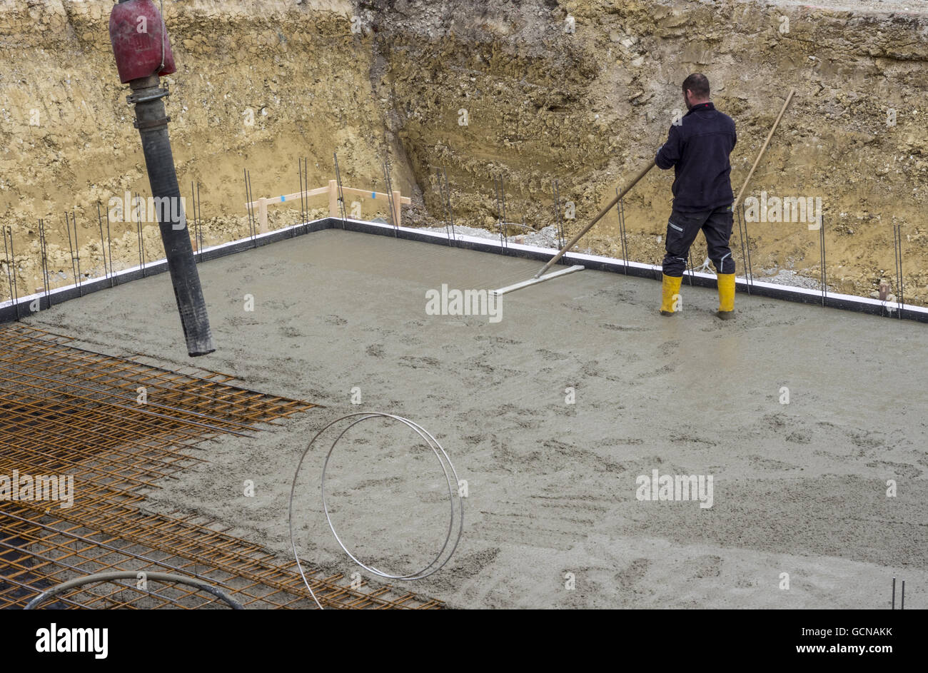 Construction worker when concreting a foundation base slab construction  Stock Photo - Alamy