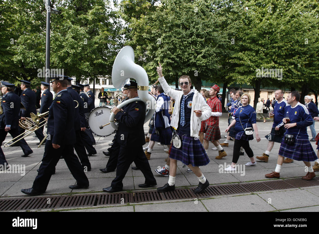 Scottish football fans having fun in the centre of Kaunas as a local Lithuanian brass band play in the streets before the UEFA European Championship Qualifing match at the Darius Girenas Stadium, Kaunas. Stock Photo