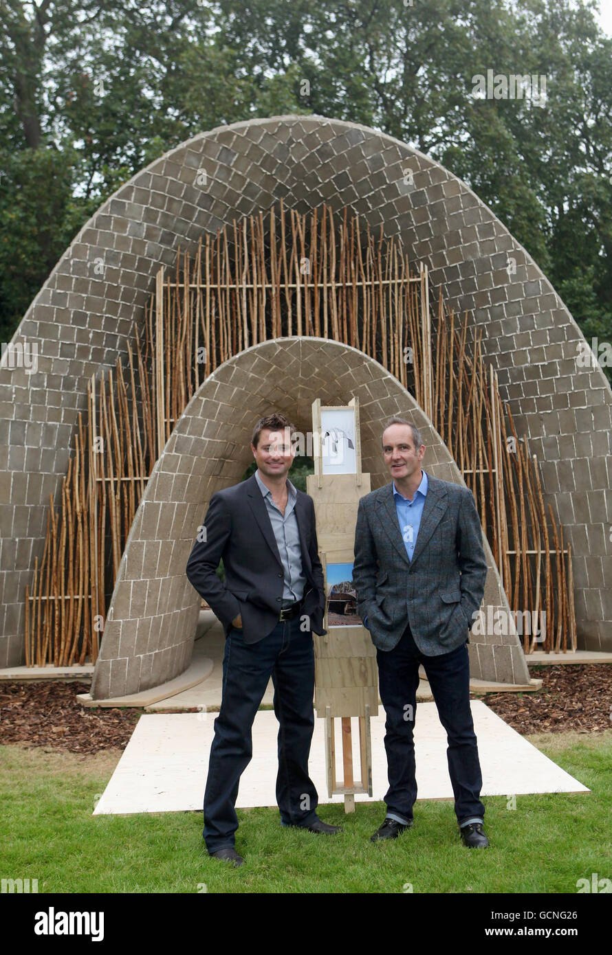 Kevin McCloud (right) and Clarke stand beside The Earth Pavillion, at the 'Garden Party