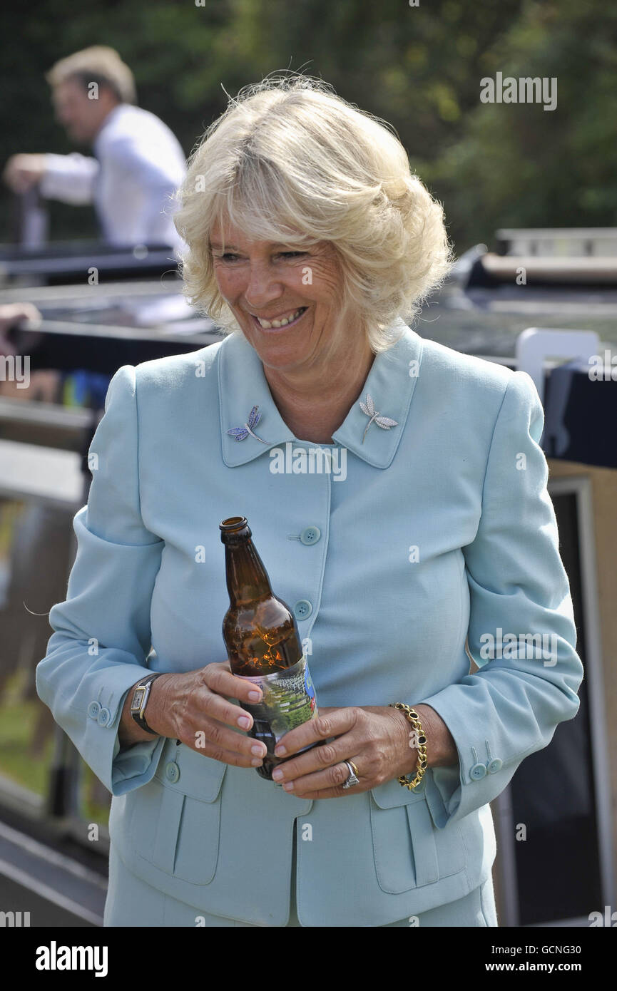 The Duchess of Cornwall holds an empty beer bottle after pouring it on a narrow trip boat to officially naming it Dragonfly as part of the celebrations for the 200th anniversary of the opening of the Wilts & Berks canal at Semington, Wiltshire. PRESS ASSOCIATION Photo. Picture date: Wednesday September 8, 2010. Photo credit should read: Ben Birchall/PA Wire Stock Photo
