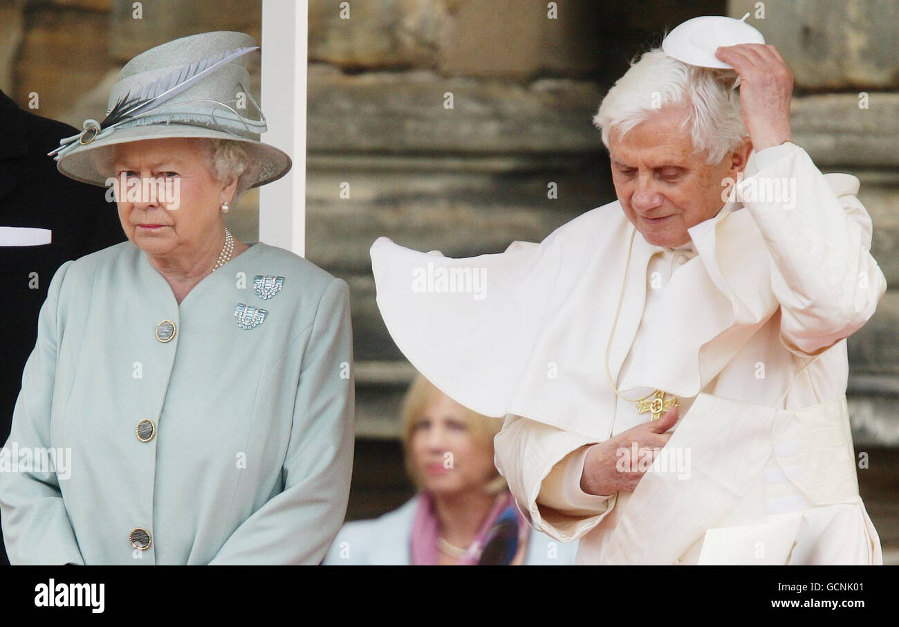 Pope Benedict XVI replaces his zucchetto as he meets with Queen Elizabeth II at the Palace of Holyroodhouse in Edinburgh on the first day of his four day visit to the United Kingdom. Stock Photo