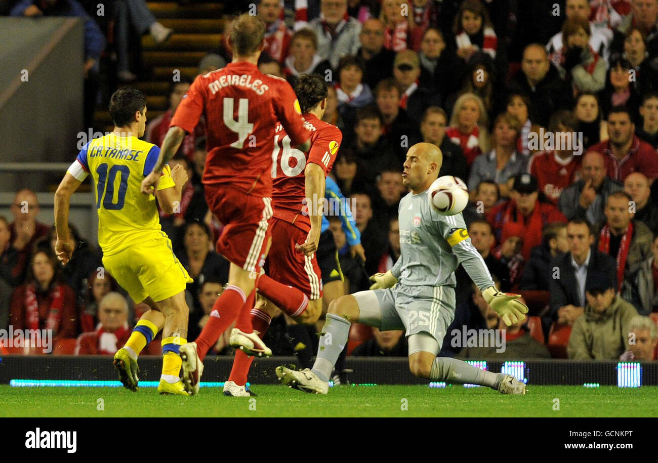 FC Steaua Bucuresti's Cristian Tanase (left) scores past Liverpool goal keeper Pepe Reina during the UEFA Europa League match at Anfield, Liverpool. Stock Photo