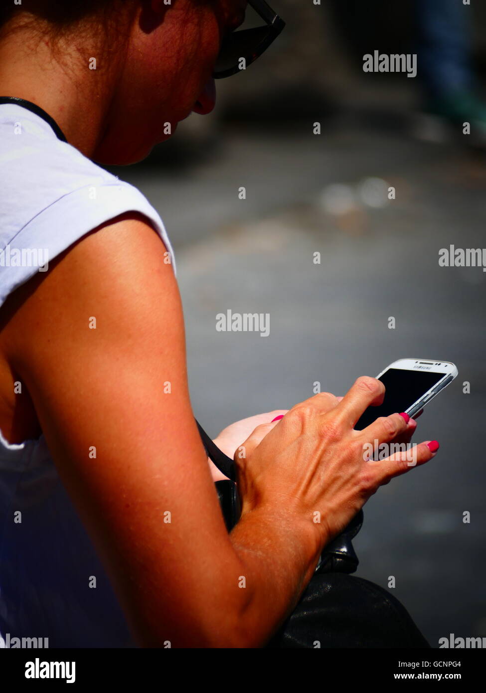 Lady Woman checking SMS email on smartphone iPhone Stock Photo