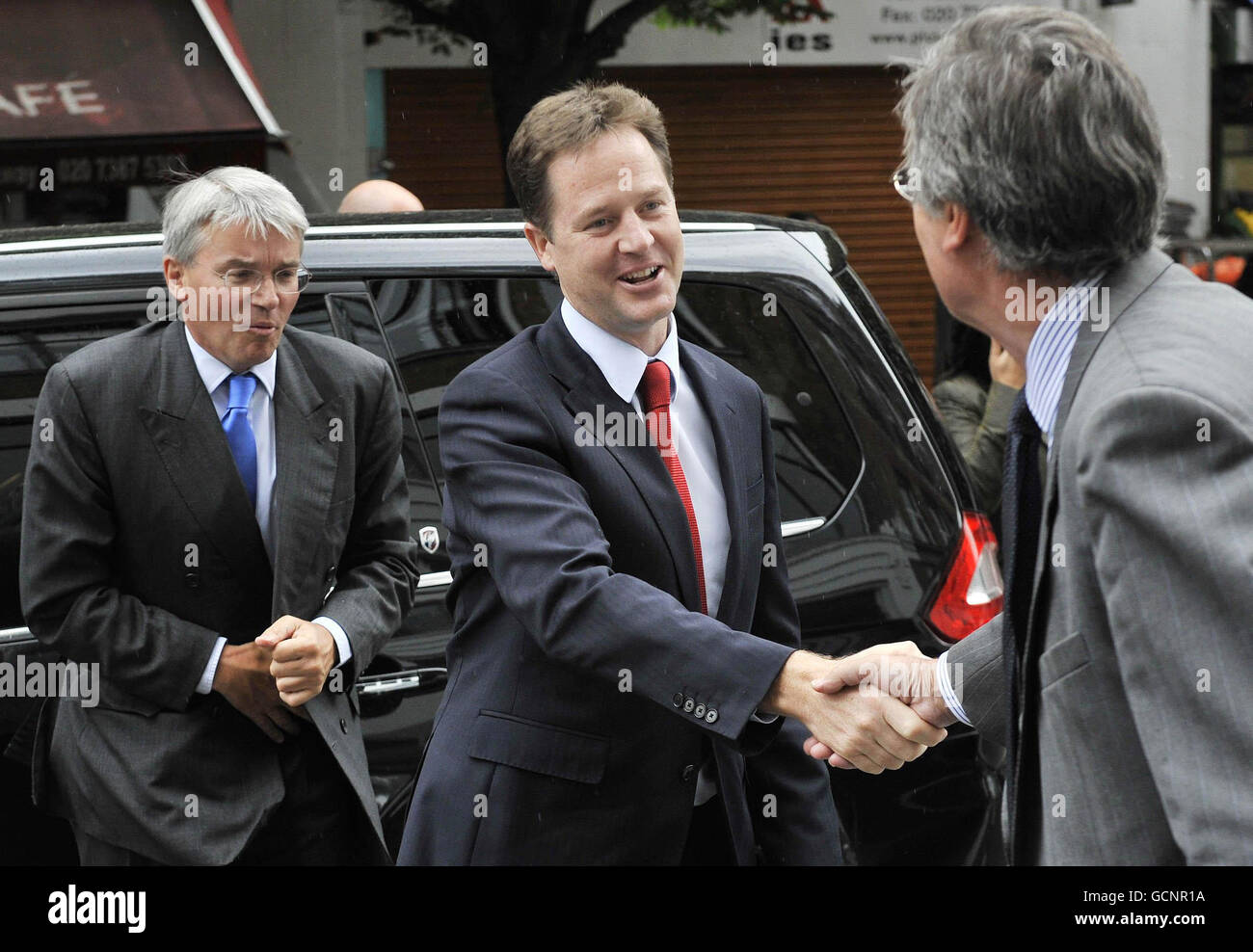 Deputy Prime Minister Nick Clegg and International Development Secretary Andrew Mitchell (left) are greeted by Disasters Emergency Committee CEO Brendan Gormley as they arrive at the headquarters in London. Stock Photo