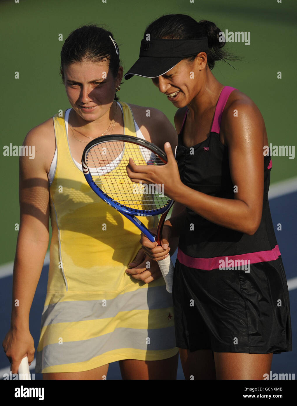 Great Britain's Anne Keothavong and doubles partner Anastasija Sevastova (left) in action against Switzerland's Timea Bacsinszky and Tathiana Garbin (out of picture) during day four of the US Open, at Flushing Meadows, New York, USA. Stock Photo