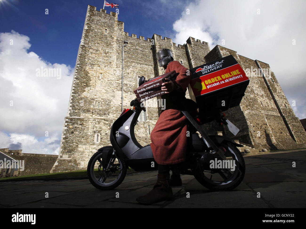 A man dressed as a medieval knight delivers a Pizza Hut medieval inspired pizza to English Heritage's flagship property, Dover Castle in Kent as part of a celebration of medieval food and drink throughout September. Stock Photo