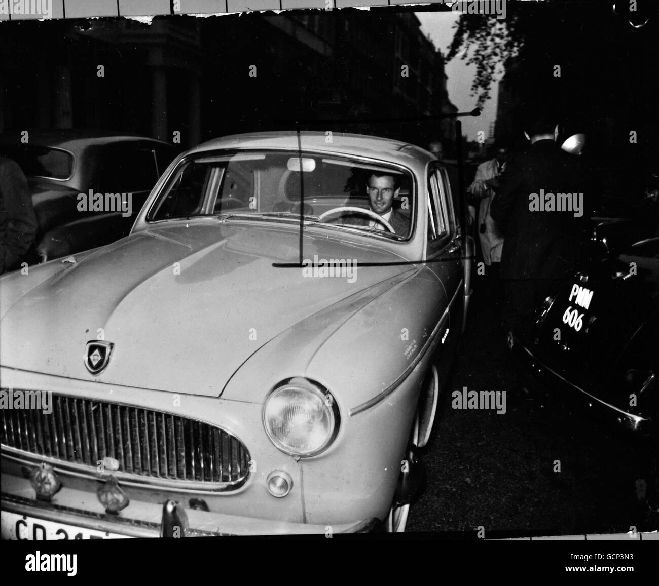 Smiling happily, group Captain Peter Townsend drives off on October 14th 1955 from the Marquese of Abergavenny's house in Lowndes Square, London, where he has been staying. The Group Captain refused to comment on speculations linking his name romantically with that of Princess Margaret and would say only that he was going away for the weekend. He refused to name his destination. Stock Photo