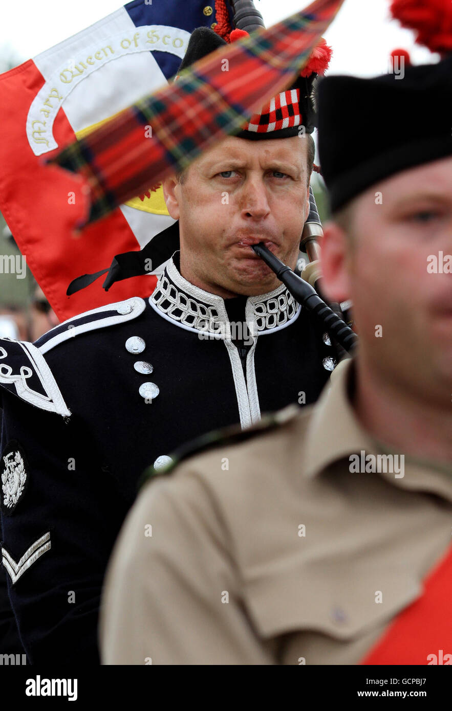 Members of the Normandy Pipe Bands leave Sword Beach in Colleville