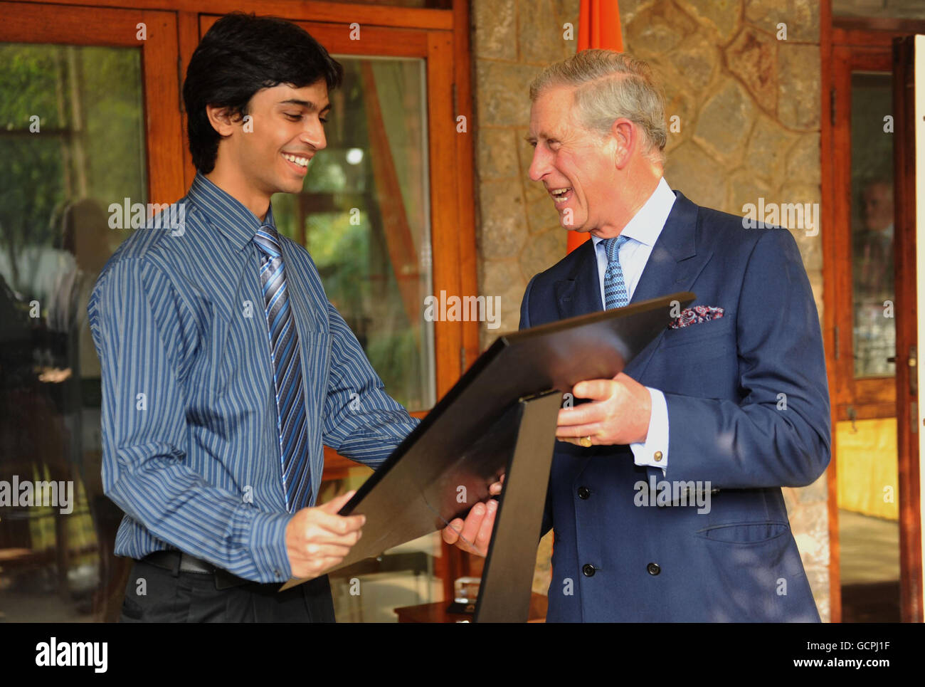 The Prince of Wales meets presents the British High Commission trophy to a student from Jwalamukhi House as he meets students from the Indian Institute of Technology (IIT) to celebrate the institution's golden jubilee at the British High Commission in New Delhi, India during a visit to the country with the Duchess of Cornwall. Stock Photo