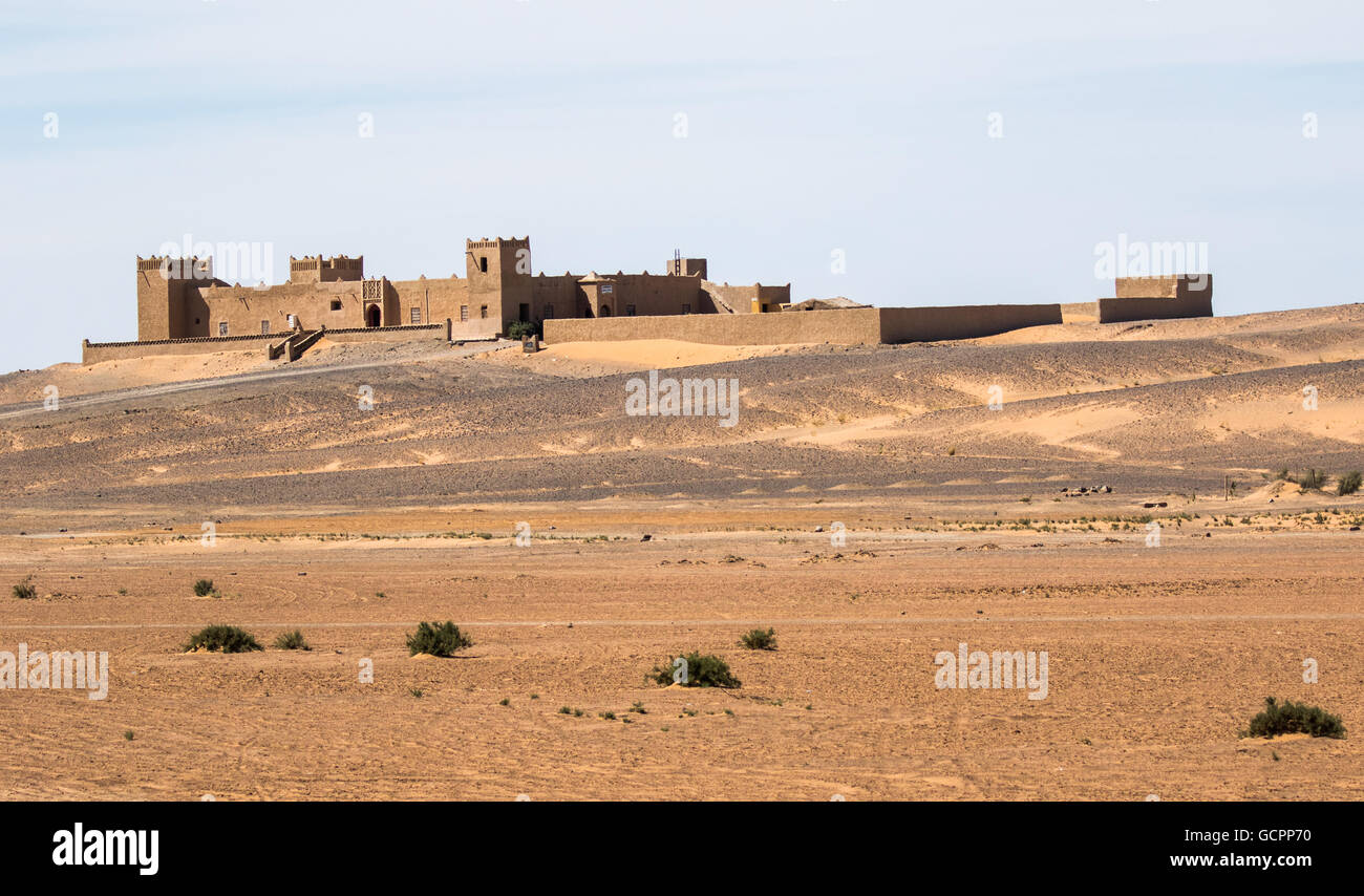 Morocco fortress in the Draa Valley desert, blue sky, scrub in foreground  Stock Photo - Alamy