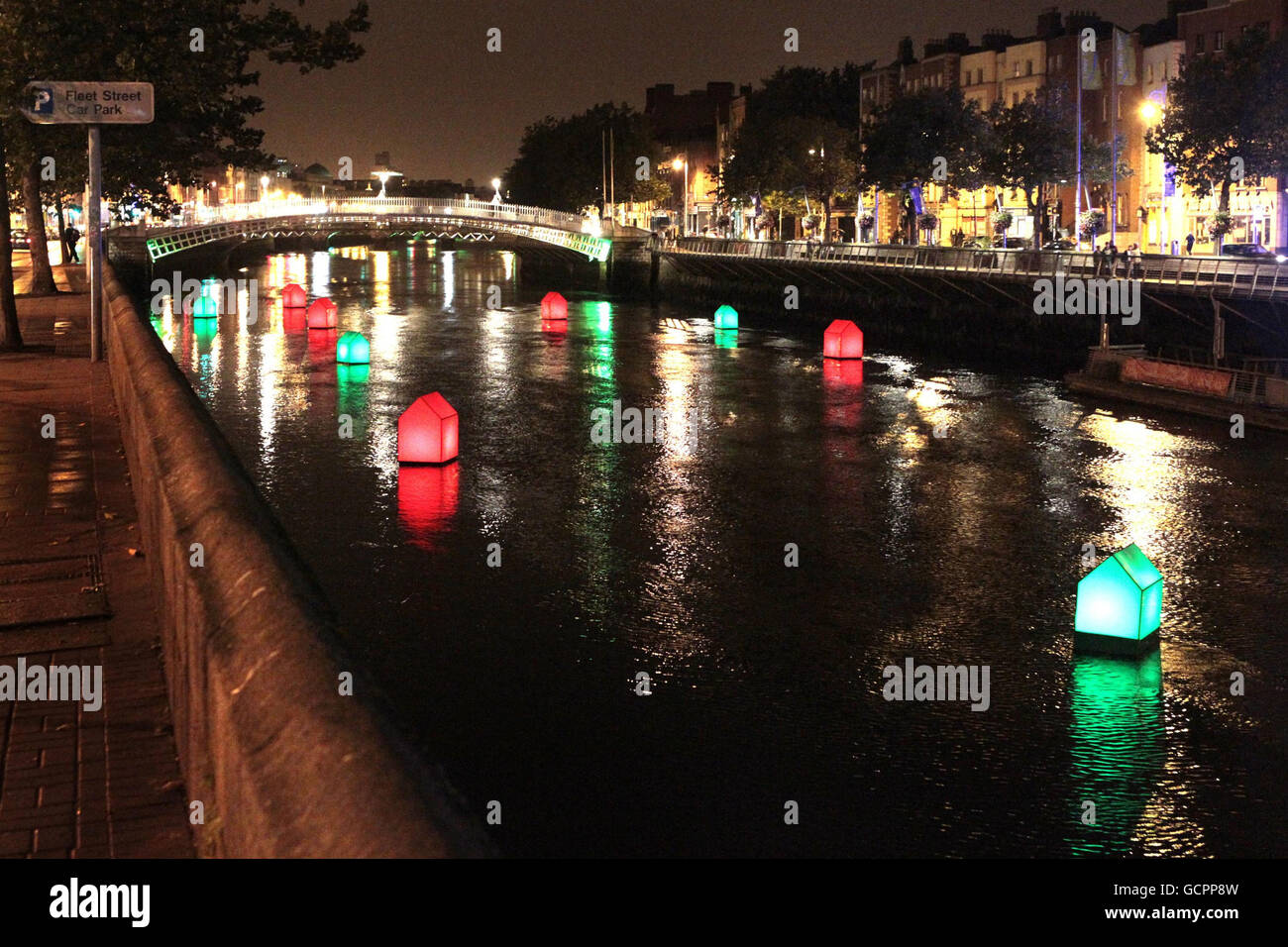 Artist Fergal McCarthy in association with Absolut Fringe brings a public art installation 'Liffeytown' to Dublin's Liffey river of eleven red and green houses. Stock Photo