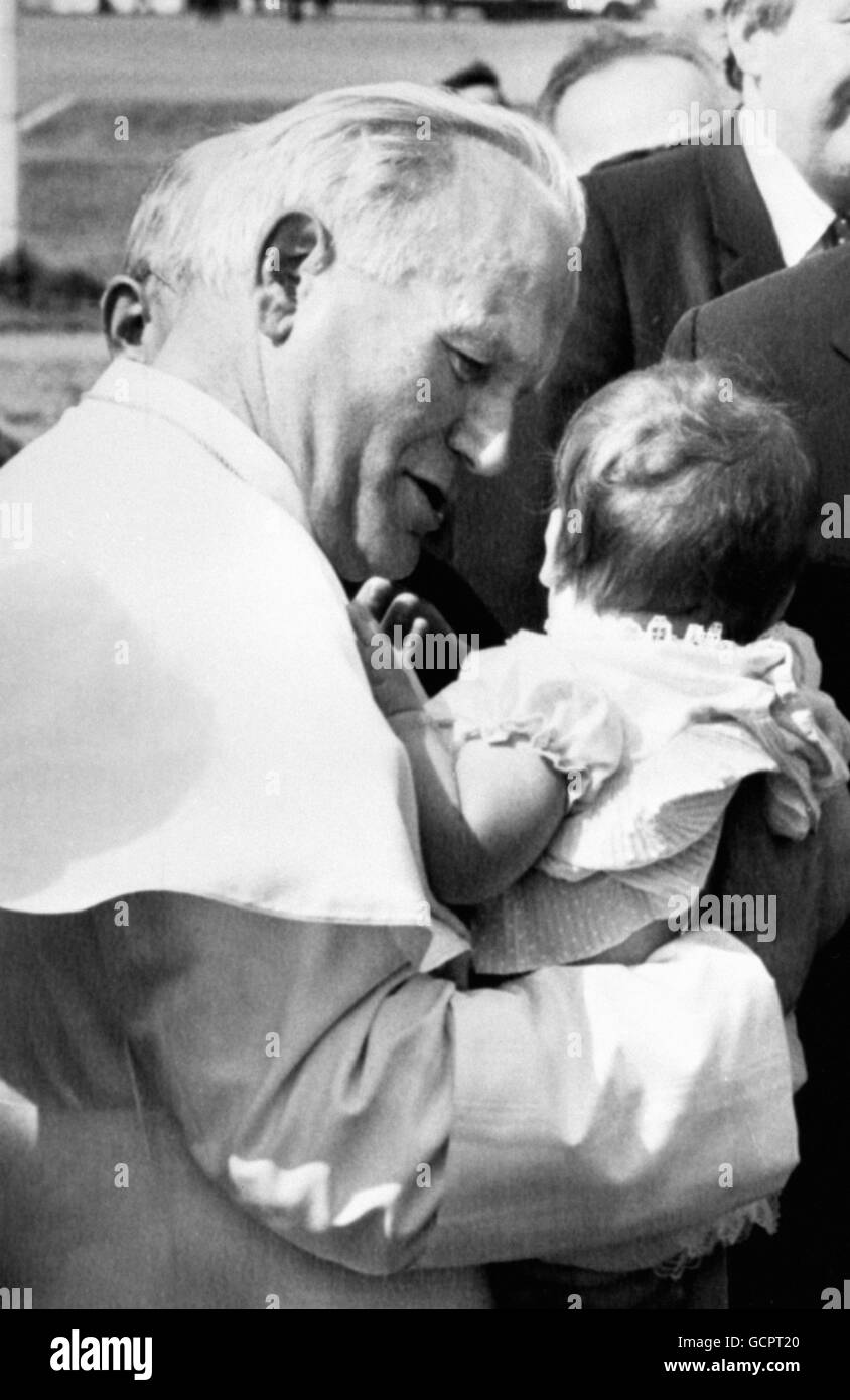 Pope John Paul II holds a young child in his arms. Stock Photo