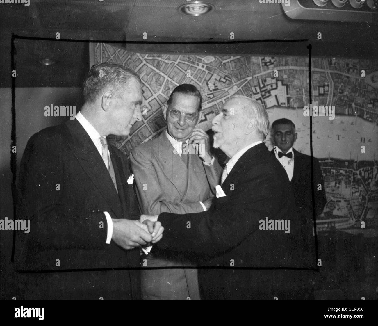 Sir Thomas Beecham, the conductor, has a cordial greeting for Mr. Norman Collins, commercial TV personality (left) at the second International Celebrity Luncheon at the Royal Festival Hall, London on September 27th 1954, centre is Mr. Neville Cardus Stock Photo