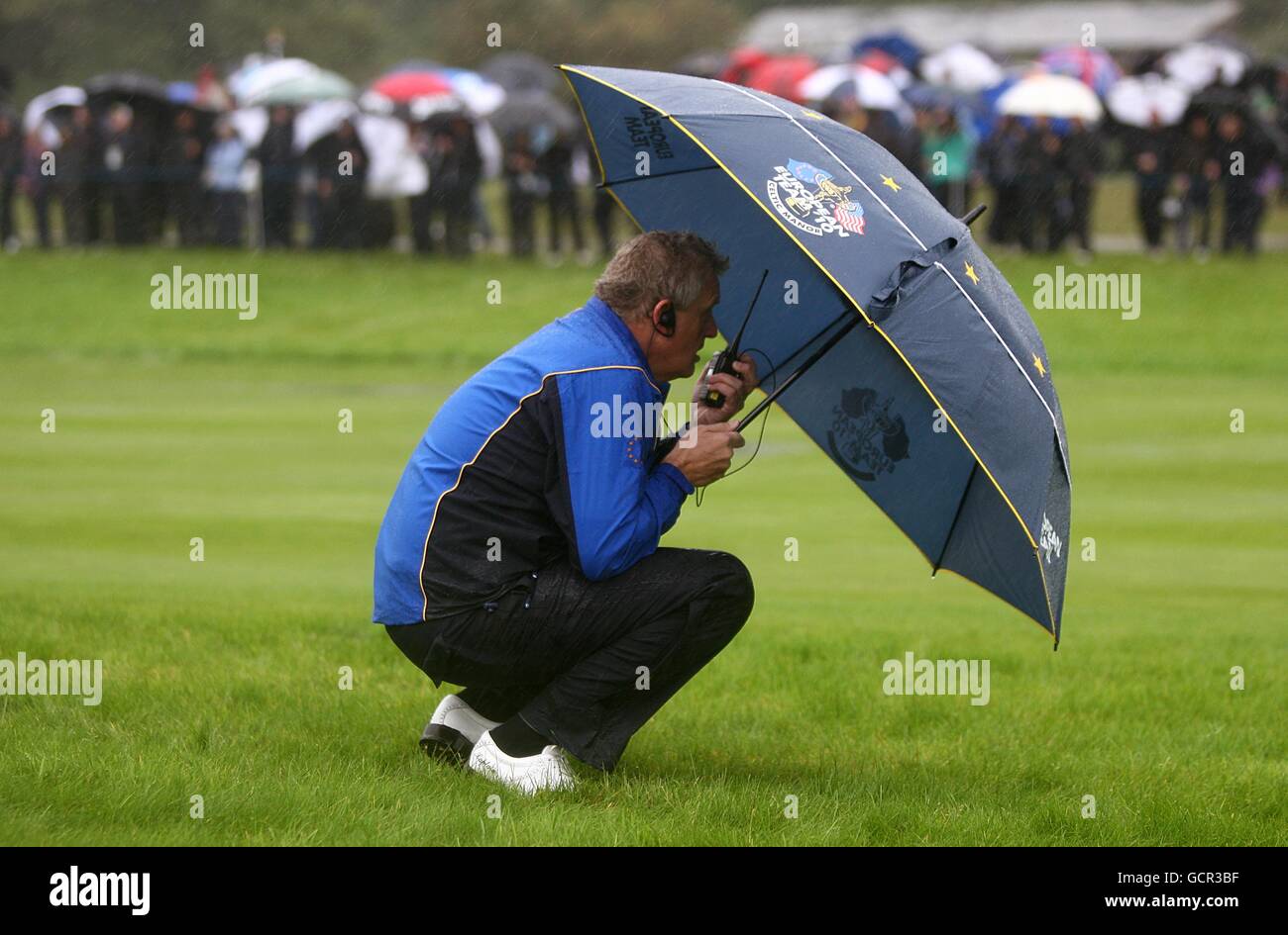 Europe Captain Colin Montgomerie waits to hear for news as play is suspended due to bad weather during the friday fourball round Stock Photo