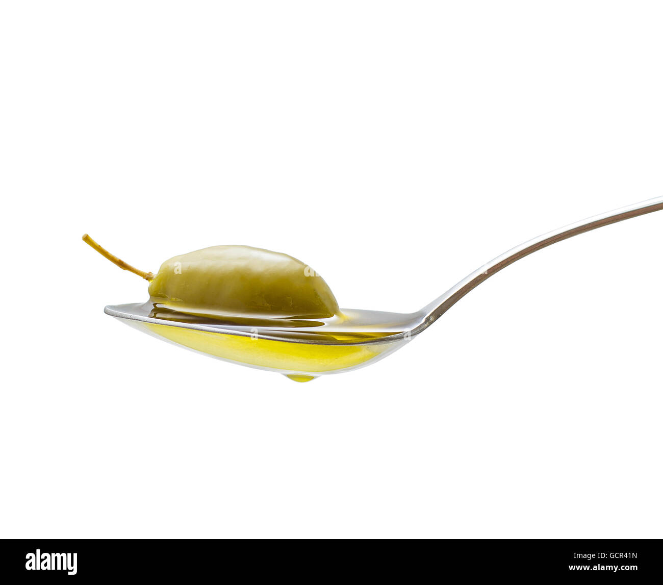 Green olive in full oil spoon on white background, isolated Stock Photo