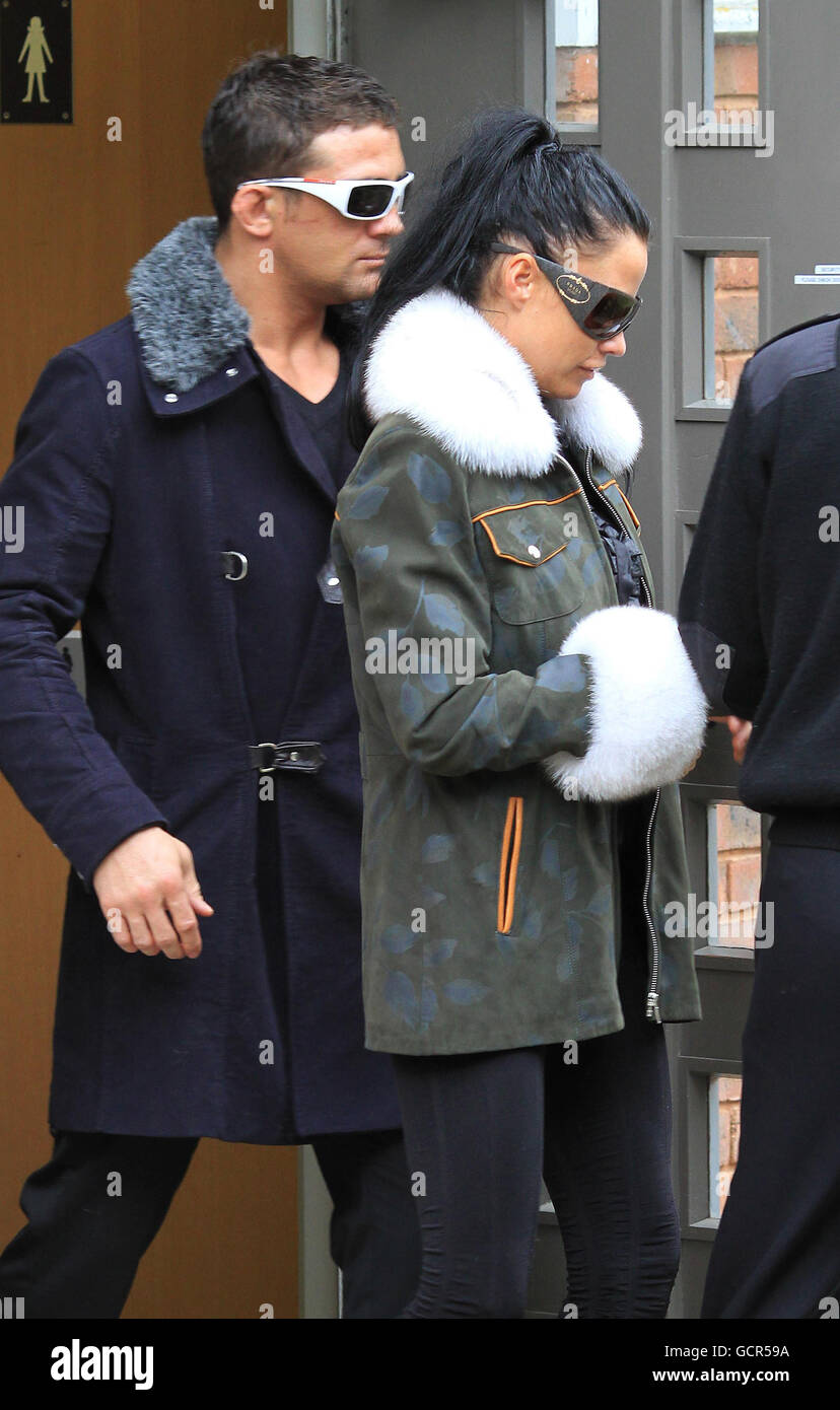 Model Katie Price and her husband Alex Reid, leave from a side entrance at Mid Sussex Magistrates Court in Haywards Heath, Sussex where she faced a charge of not being in proper control of a vehicle. Model Katie Price was seen by police using a mobile phone while driving a large pink horsebox, the court heard today. Stock Photo
