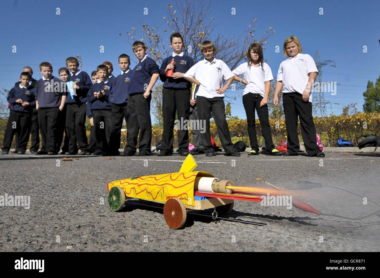 Schoolchildren watch as their self-built model rocket propelled cars speed along a mock track as part of the BLOODHOUND educational schools programme. BLOODHOUND aims to become the world's fastest land vehicle by breaking the 1000mph barrier to set a new world record in South Africa in 2012. Stock Photo