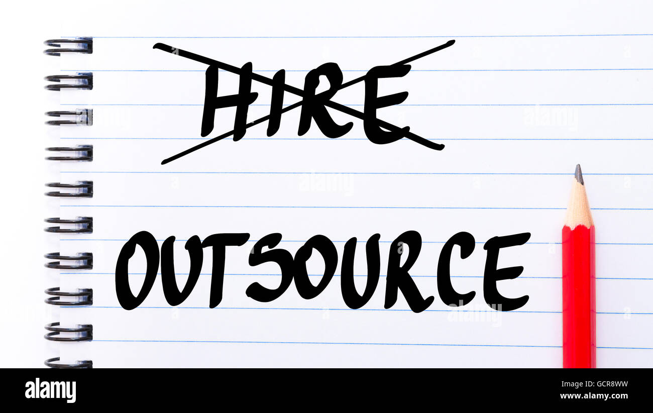Outsource instead of Hire written on notebook page with red pencil on the right Stock Photo