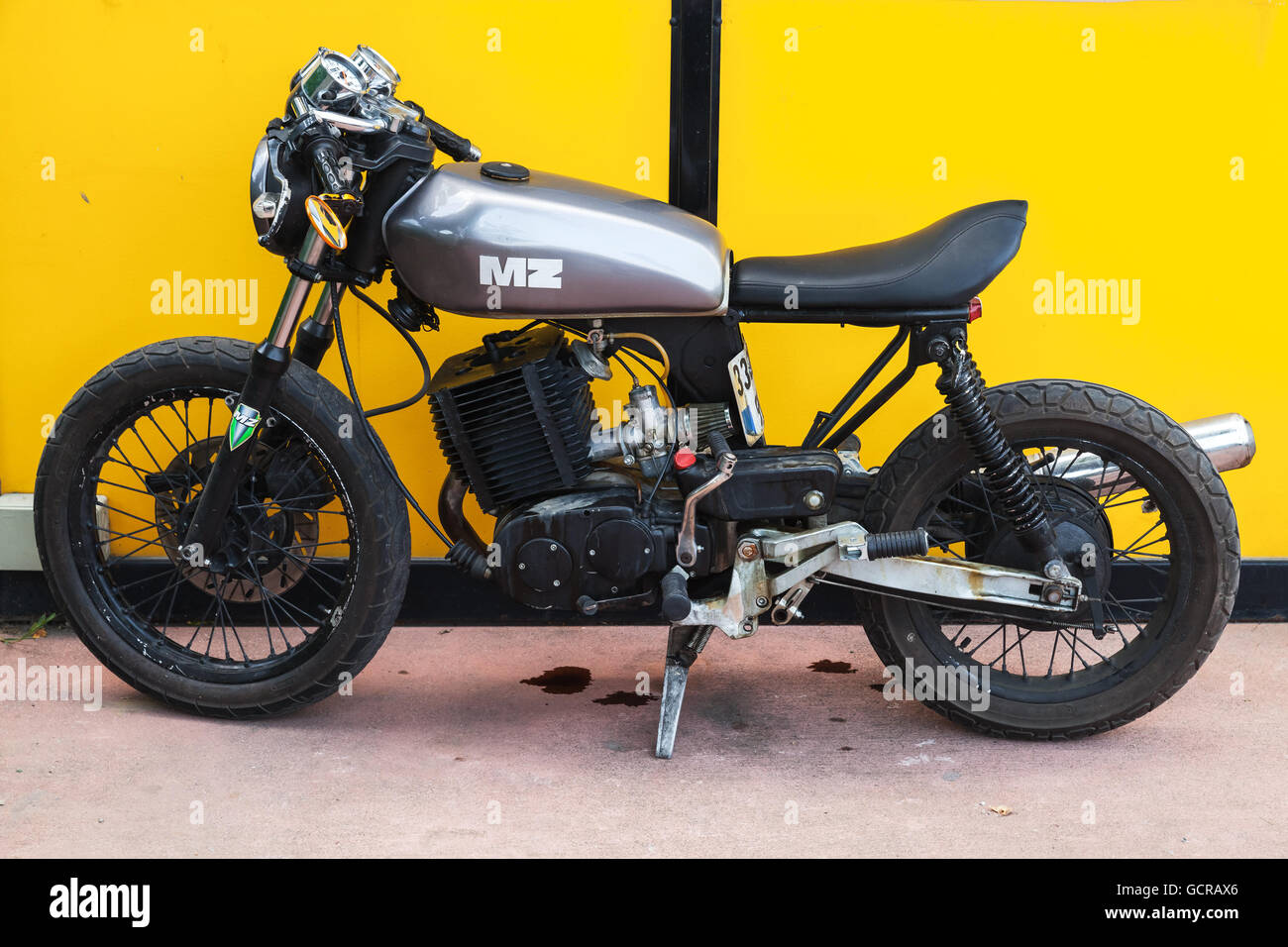 Istanbul, Turkey - July 1, 2016: Black German MZ motorcycle stands near yellow wall Stock Photo