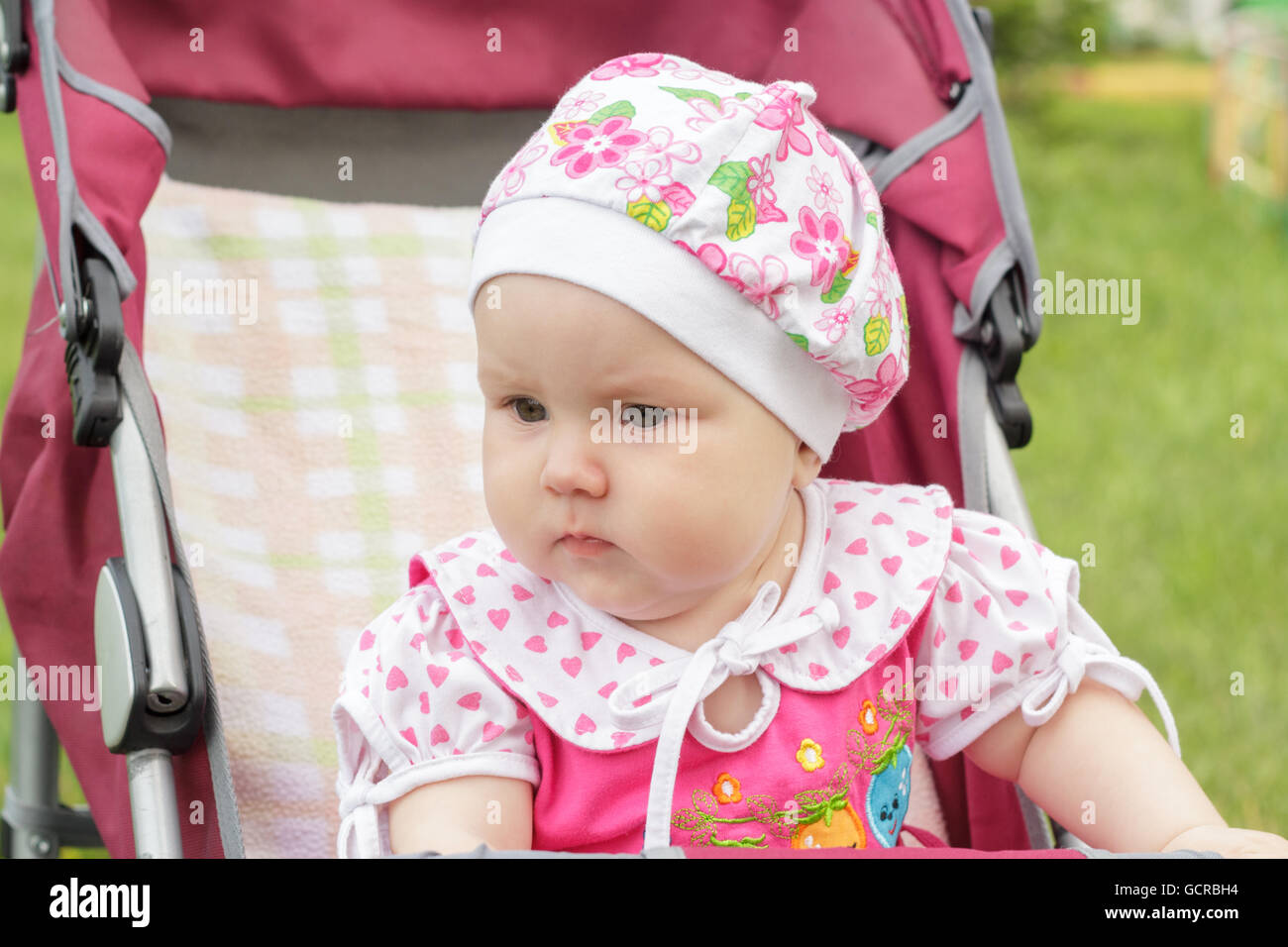 little newborn girl sitting in a baby carriage Stock Photo - Alamy