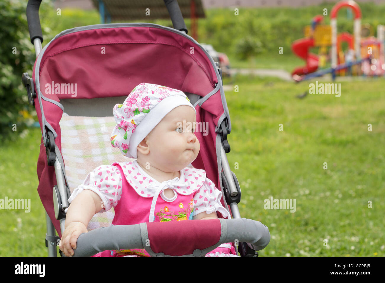 little newborn girl sitting in a baby carriage Stock Photo - Alamy