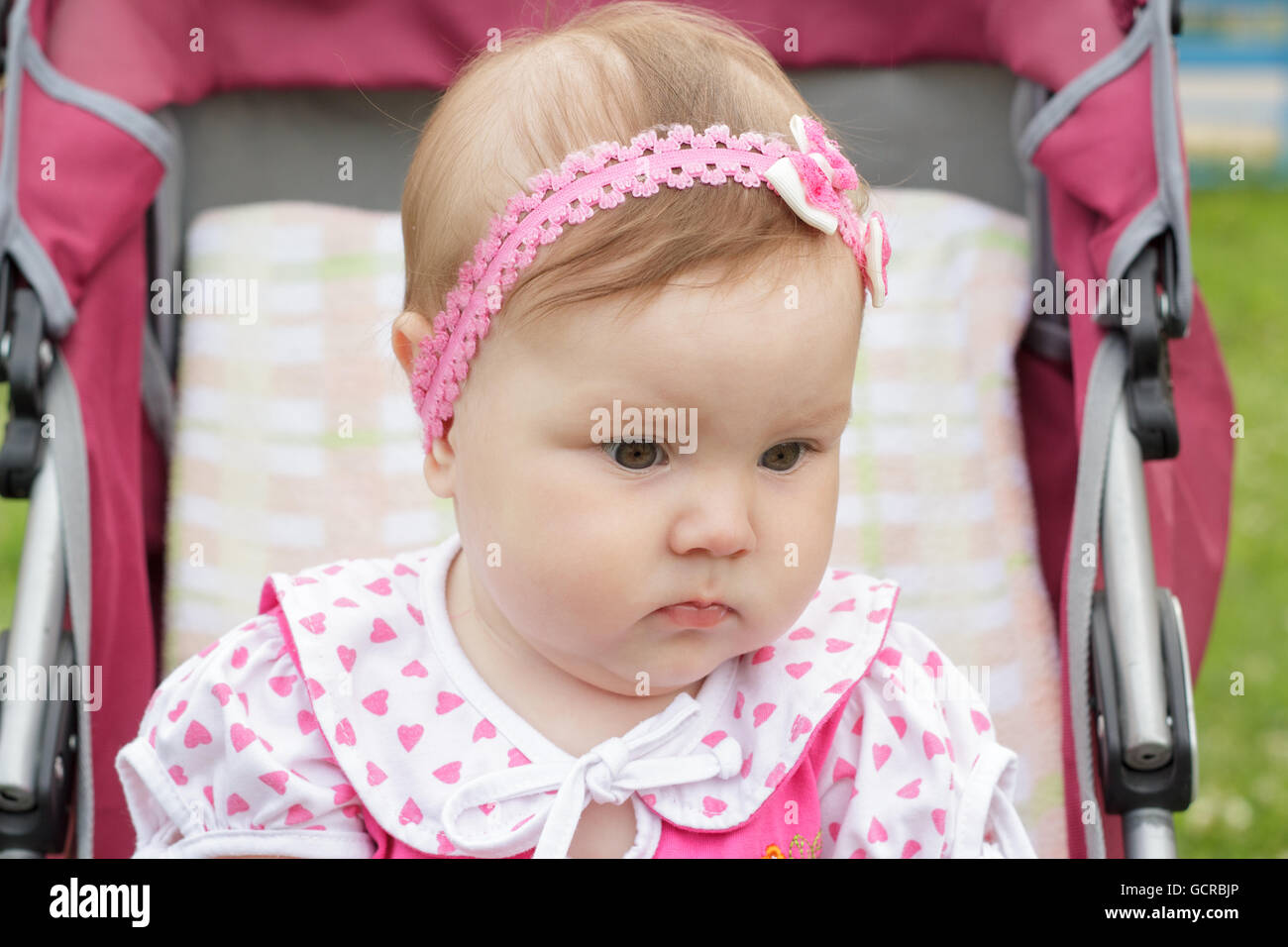 little newborn girl sitting in a baby carriage Stock Photo - Alamy