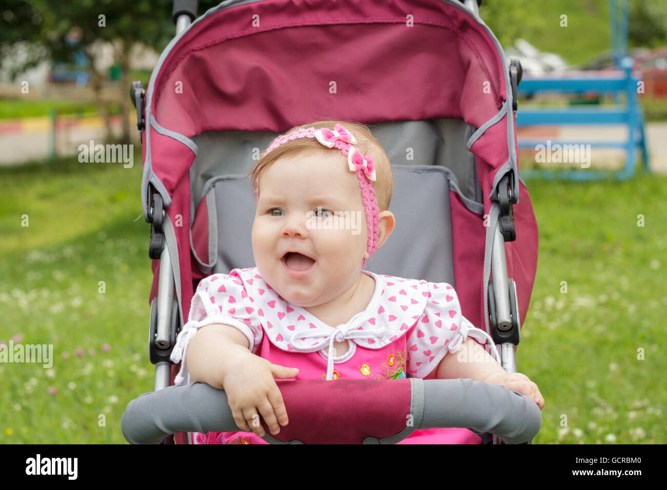 little newborn girl sitting in a baby carriage Stock Photo - Alamy