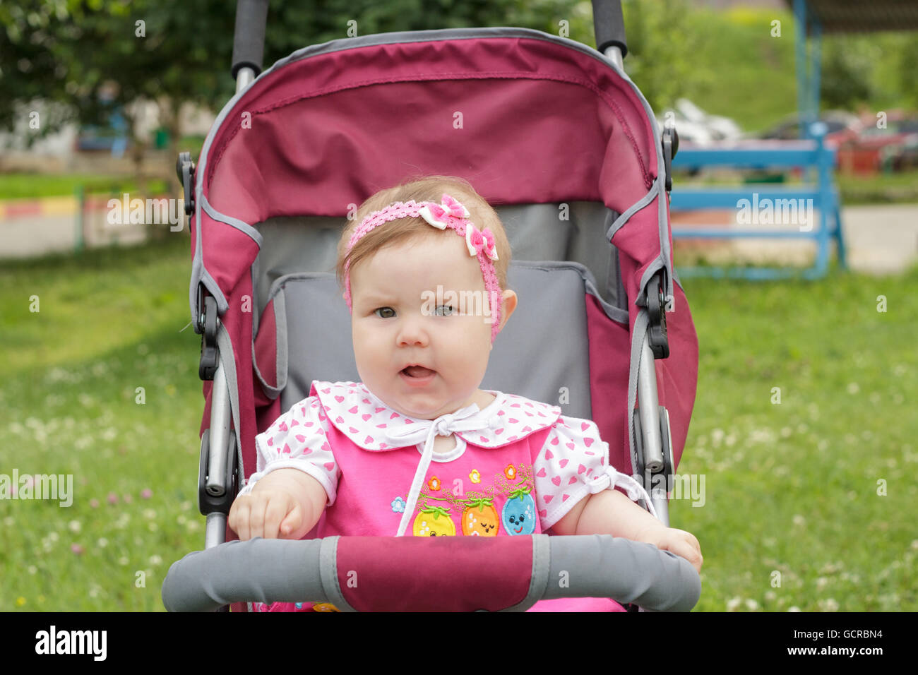 little newborn girl sitting in a baby carriage Stock Photo - Alamy