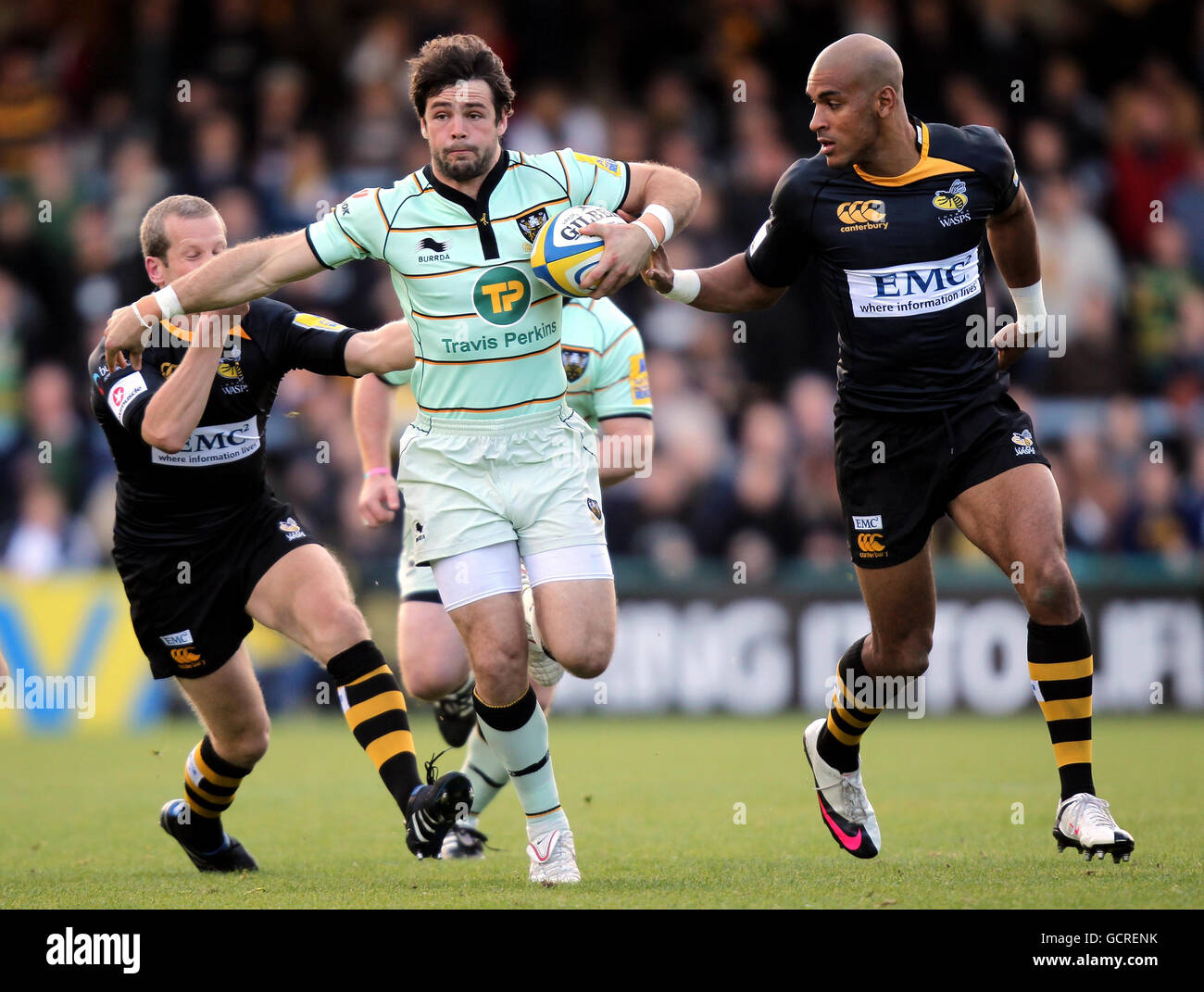 Northampton's Ben Foden (centre) gets away from Wasps' Dave Walder and ...