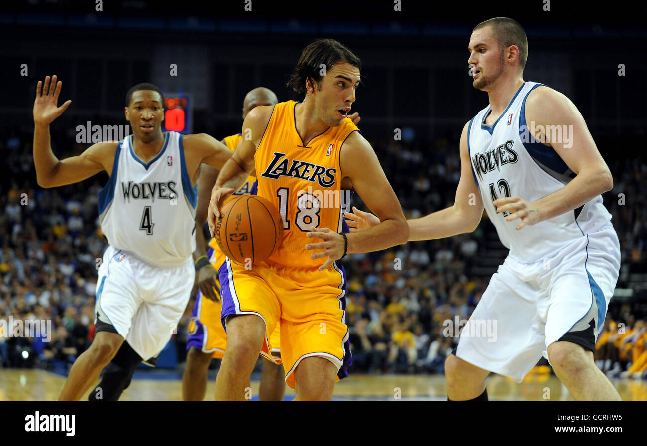 LA Lakers' Sasha Vujacic (centre) takes on Minnesota Timberwolves' Kevin Love (right) during the NBA Europe Live match at the O2 Arena, London. Stock Photo