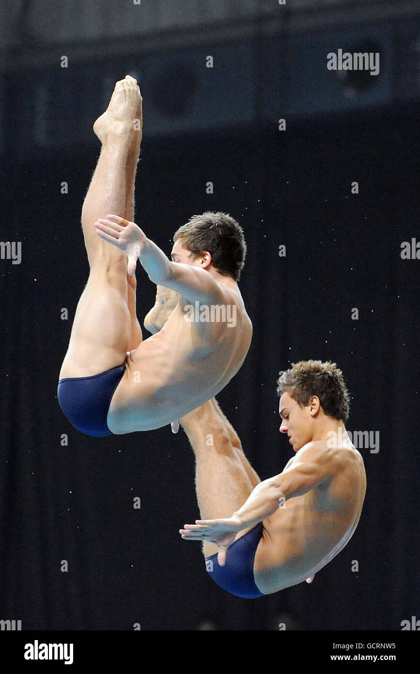 England's Max Brick and Tom Daley on their way to a gold medal in the Men's 10m Synchro Platform during Day Nine of the 2010 Commonwealth Games at the Dr SPM Swimming Complex in New Dehli, India. Stock Photo