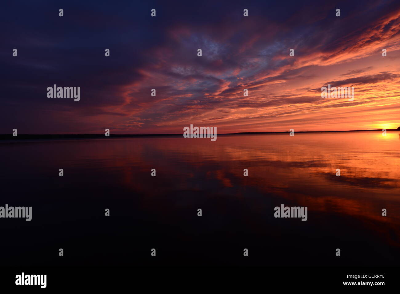 Sunset sky reflected on lake water surface Stock Photo - Alamy