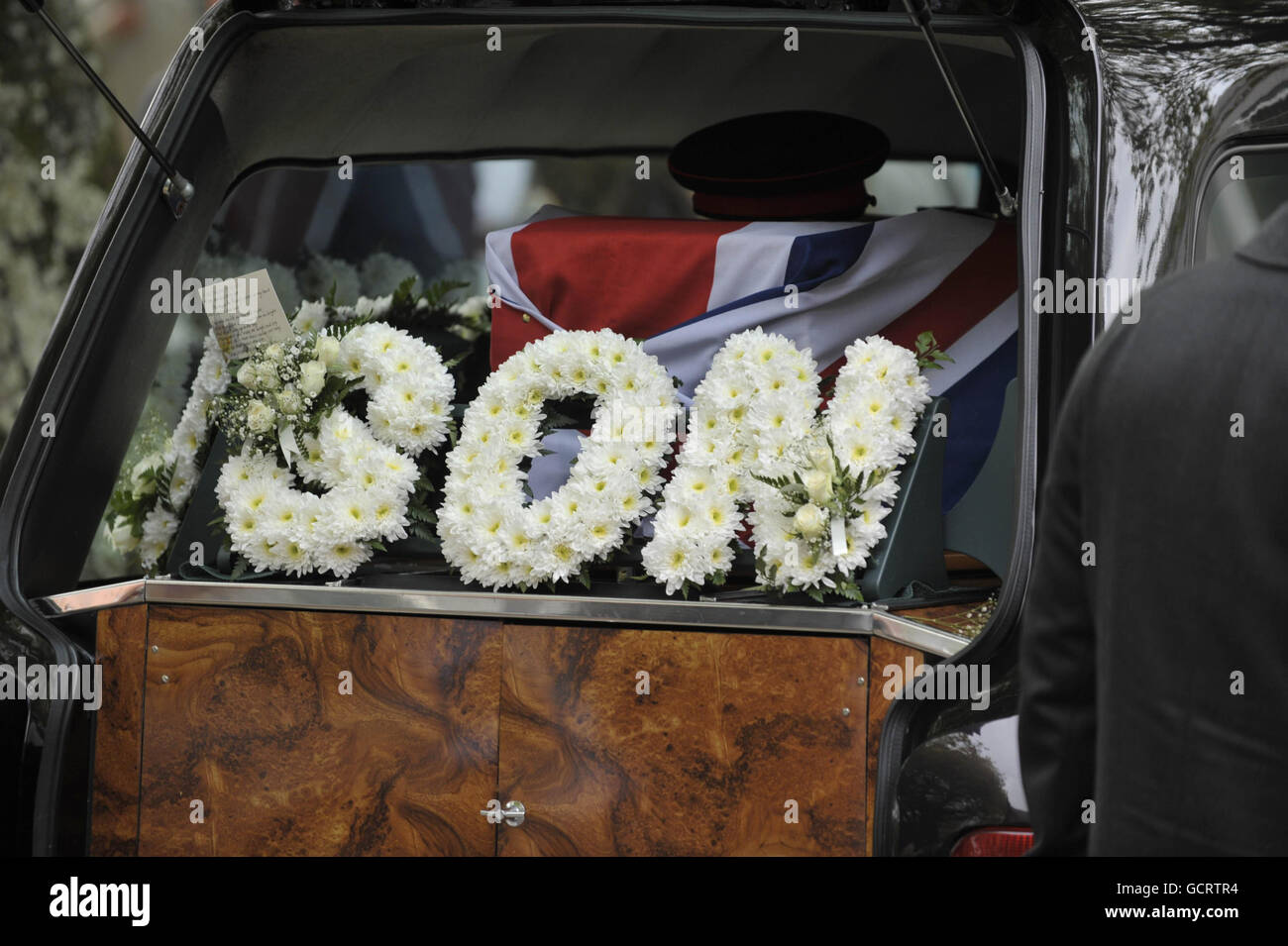 EDS NOTE: THE FACES OF FAMILY AND PALL BEARERS (Special Forces) WERE REQUESTED NOT TO BE PHOTOGRAPHED/FILMED. A floral tribute to Corporal Matthew Thomas on the hearse containing his Union Flag draped coffin outside St. Mary's Church in Swansea, where his memorial service was held. Stock Photo