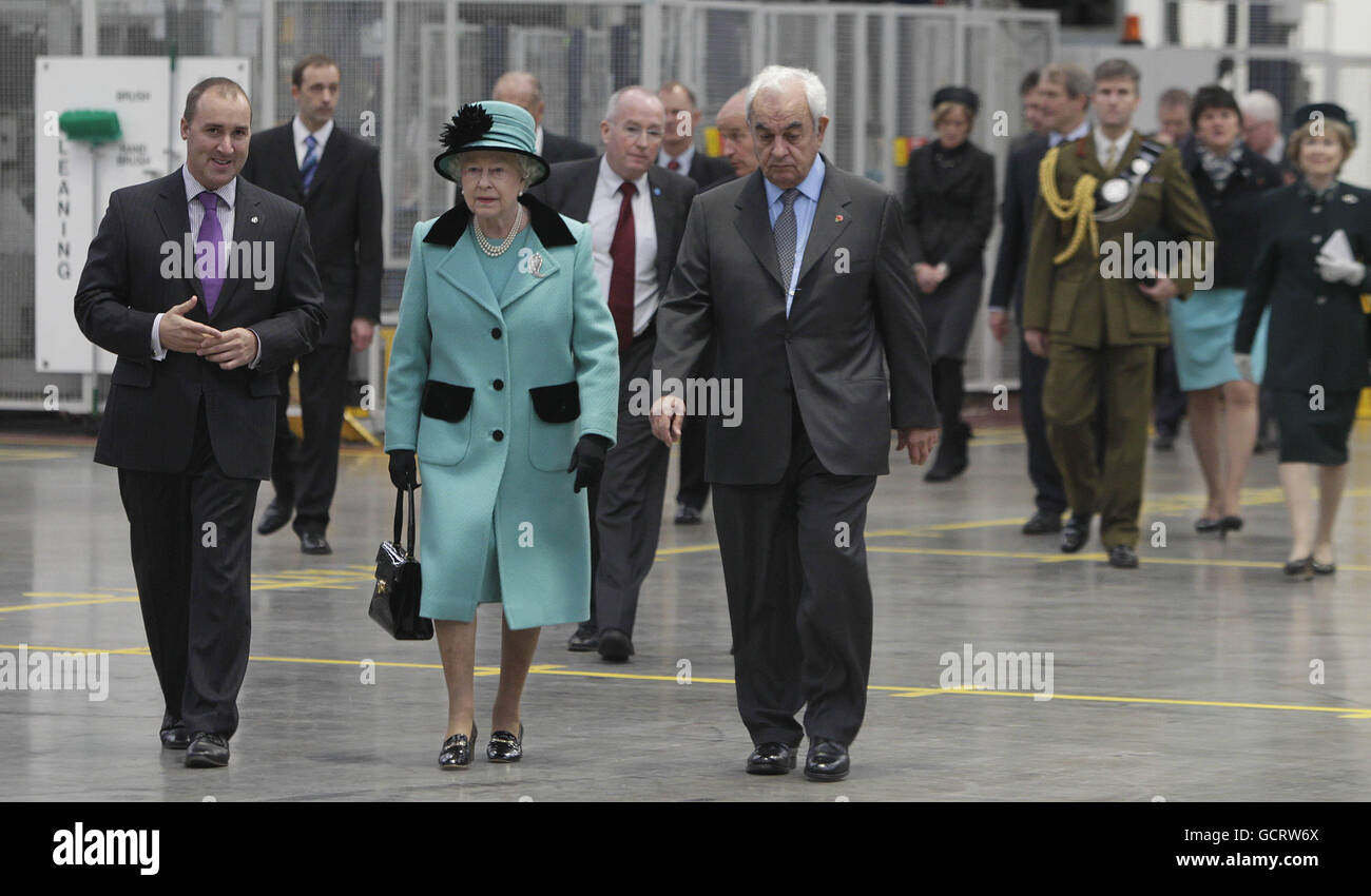 Alan Smith Regional Supply chain Director (left) and George David Chairman of Coca-Cola Hellenic (right) give Queen Elizabeth II a tour around the Coca-Cola bottling plant in Lisburn before she opened the new visitors centre. Stock Photo