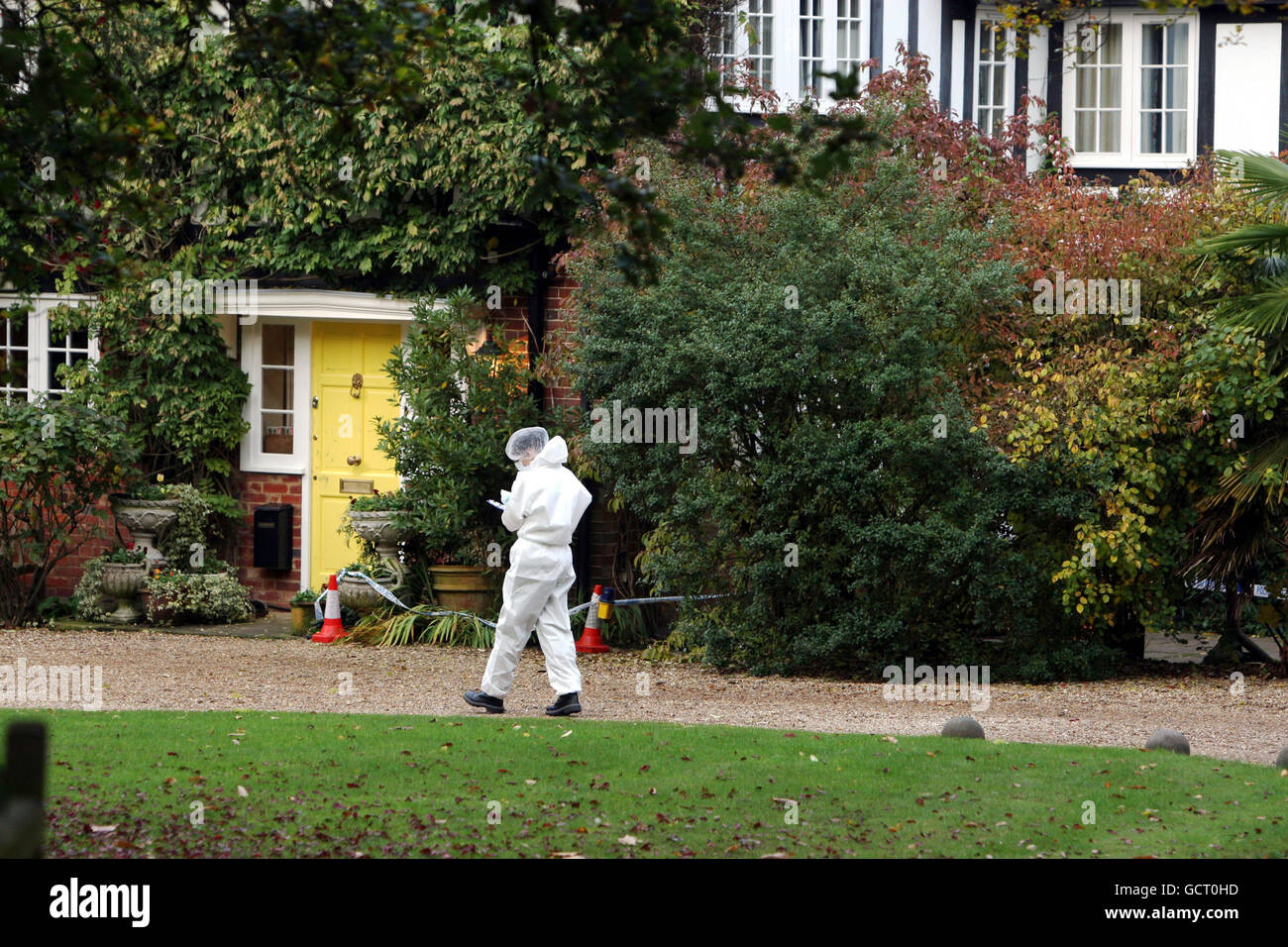 A police forensic officer at Tun Cottage in Ascot, Berkshire where the