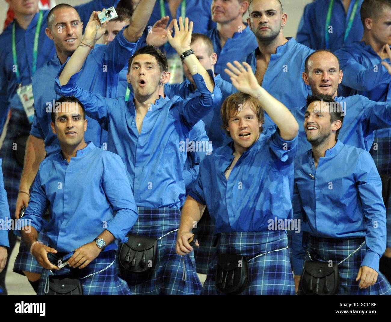 Members of the Scotland team wave during the 2010 Commonwealth Games opening ceremony at the Jawaharlal Nehru Stadium in New Delhi, India. Stock Photo