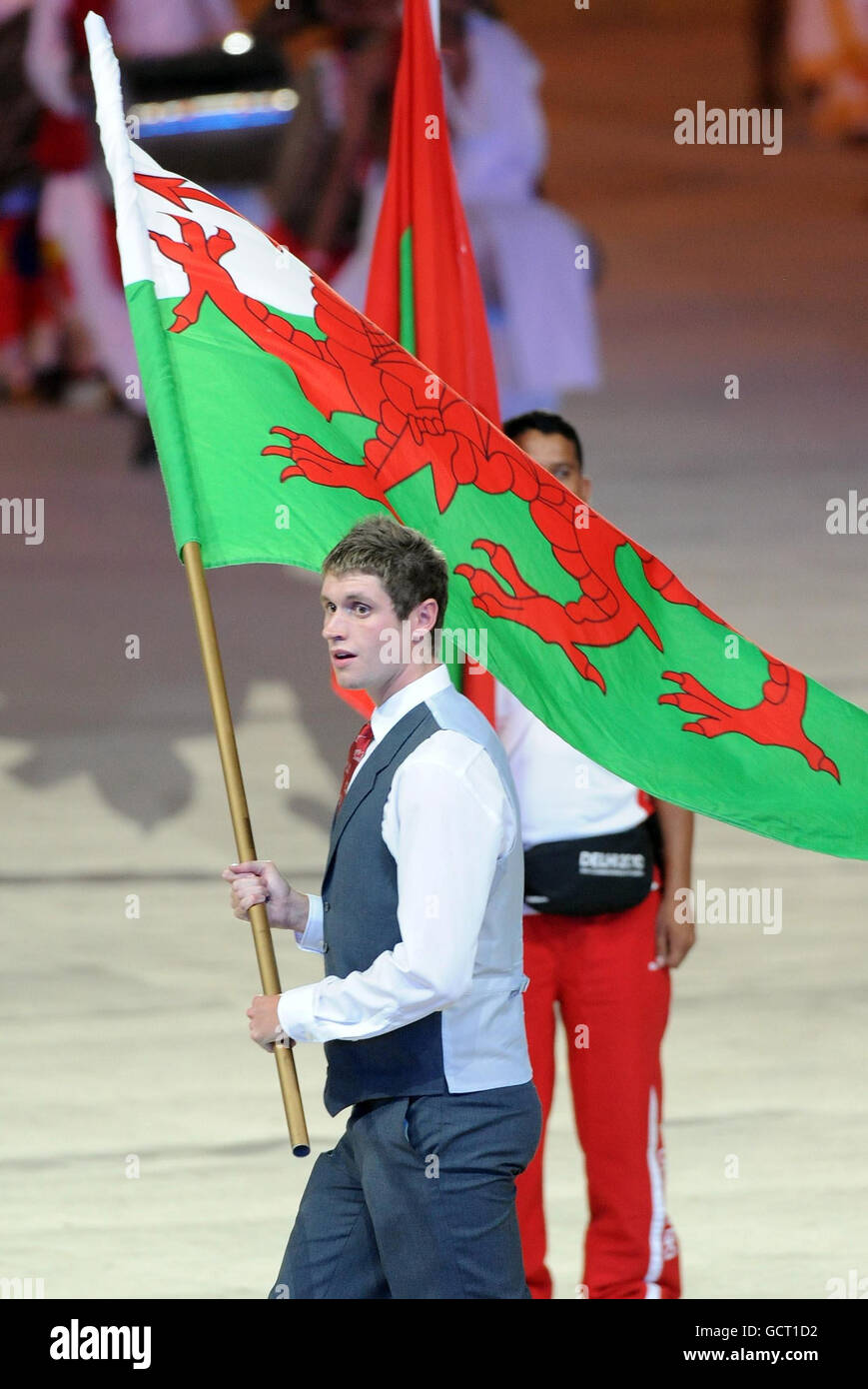 Wales' David Davies carries their flag during the 2010 Commonwealth Games opening ceremony at the Jawaharlal Nehru Stadium in New Delhi, India. Stock Photo