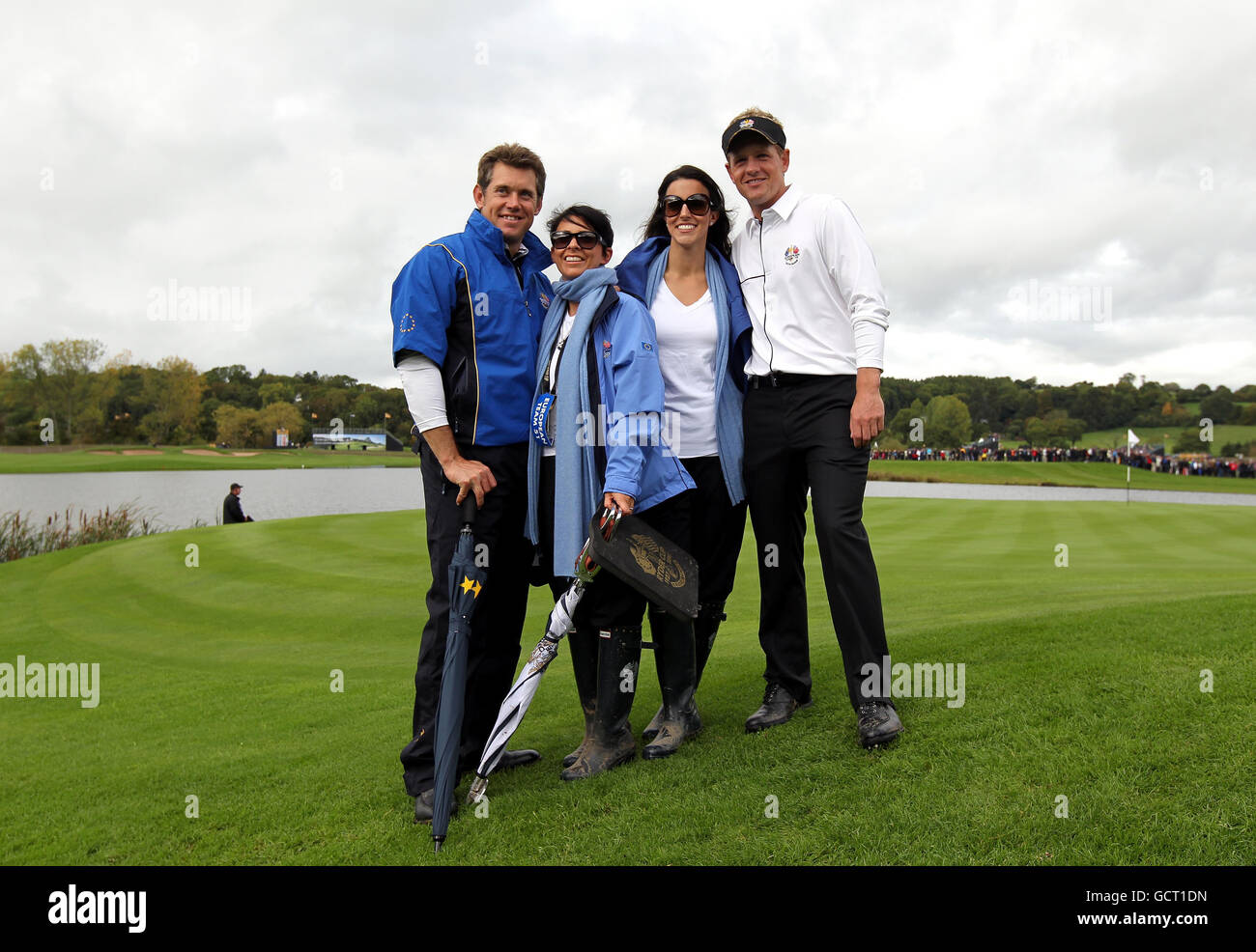 Europe's Lee Westwood (left) and his wife Laurae (second left) and Luke Donald (right) and his wife Diane Donald (second right) pose for photographers on the 13th green after they beat the USA's Tiger Woods and Steve Stricker in the session 3 foursomes, during the Ryder Cup at Celtic Manor, Newport. Stock Photo