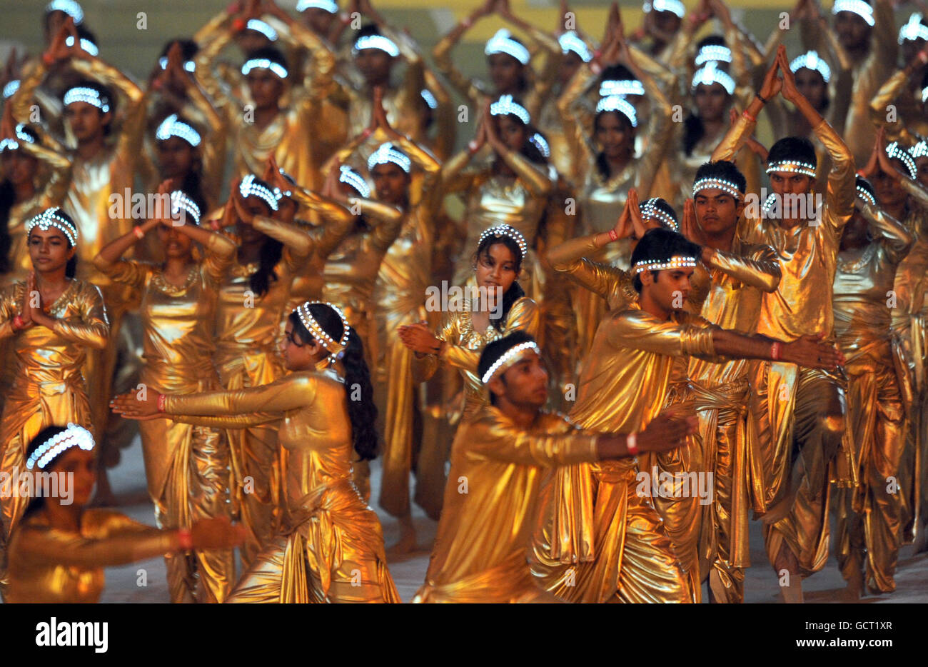 Dancers perform during the 2010 Commonwealth Games opening ceremony at the Jawaharlal Nehru Stadium in New Delhi, India. Stock Photo