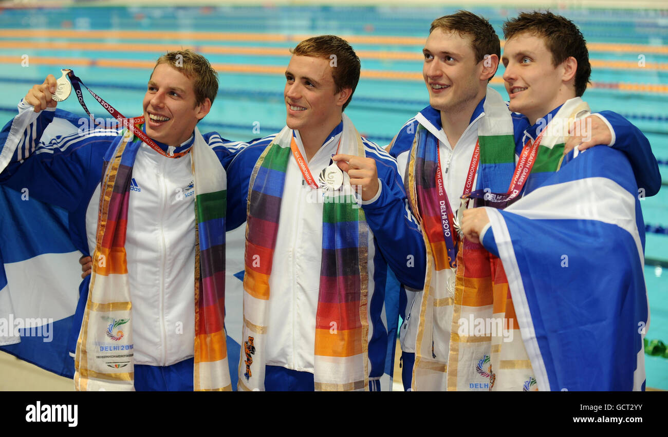 Scotland's 4x200m Silver medalists (left to right) David Carry, Robert Renwick, Andy Hunter and Jak Scott pose for the media during the Day Three of the 2010 Commonwealth Games at the Dr SPM Swimming Complex in Delhi, India. Stock Photo
