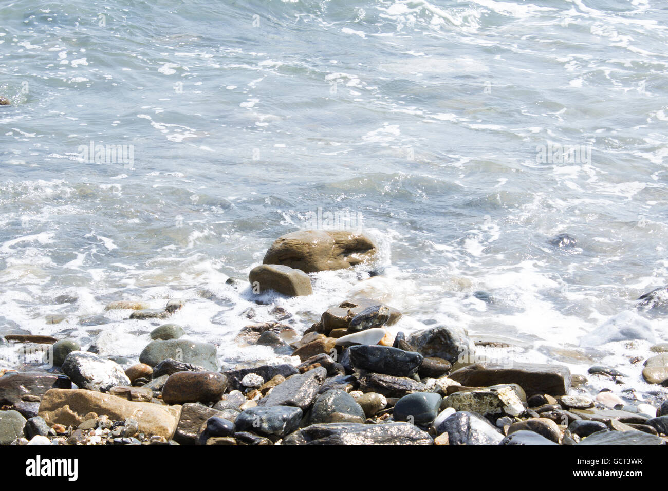 water floating around pebbles Stock Photo Alamy