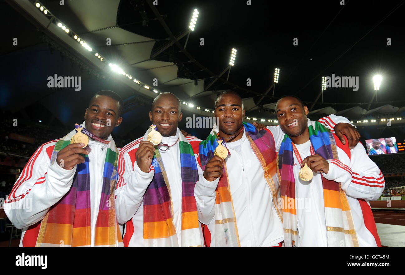 England's (left to right) Leon Baptiste, Marlon Devonish, Mark Lewis Francis and Ryan Scott celebrate with their gold medals after winning the Men's 4x100m Relay during Day Nine of the 2010 Commonwealth Games at the Jawaharlal Nehru Sports Complex in New Dehli, India. Stock Photo