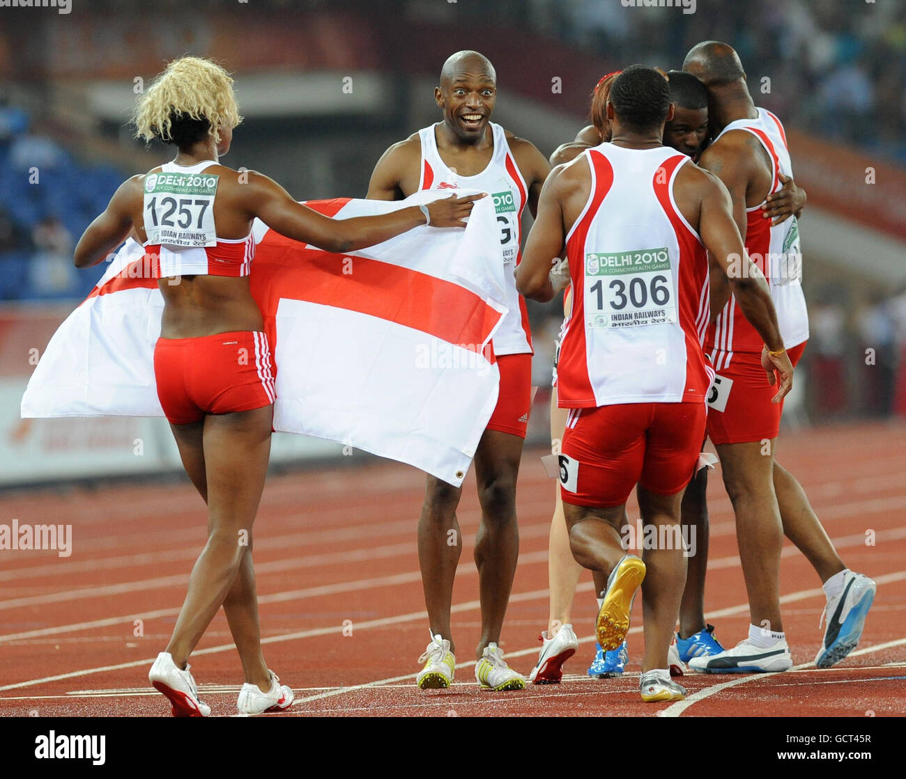 England's Marlon Devonish (centre) celebrates with the Men's and Women's 4x100m Relay teams after they both won gold during Day Nine of the 2010 Commonwealth Games at the Jawaharlal Nehru Sports Complex in New Dehli, India. Stock Photo