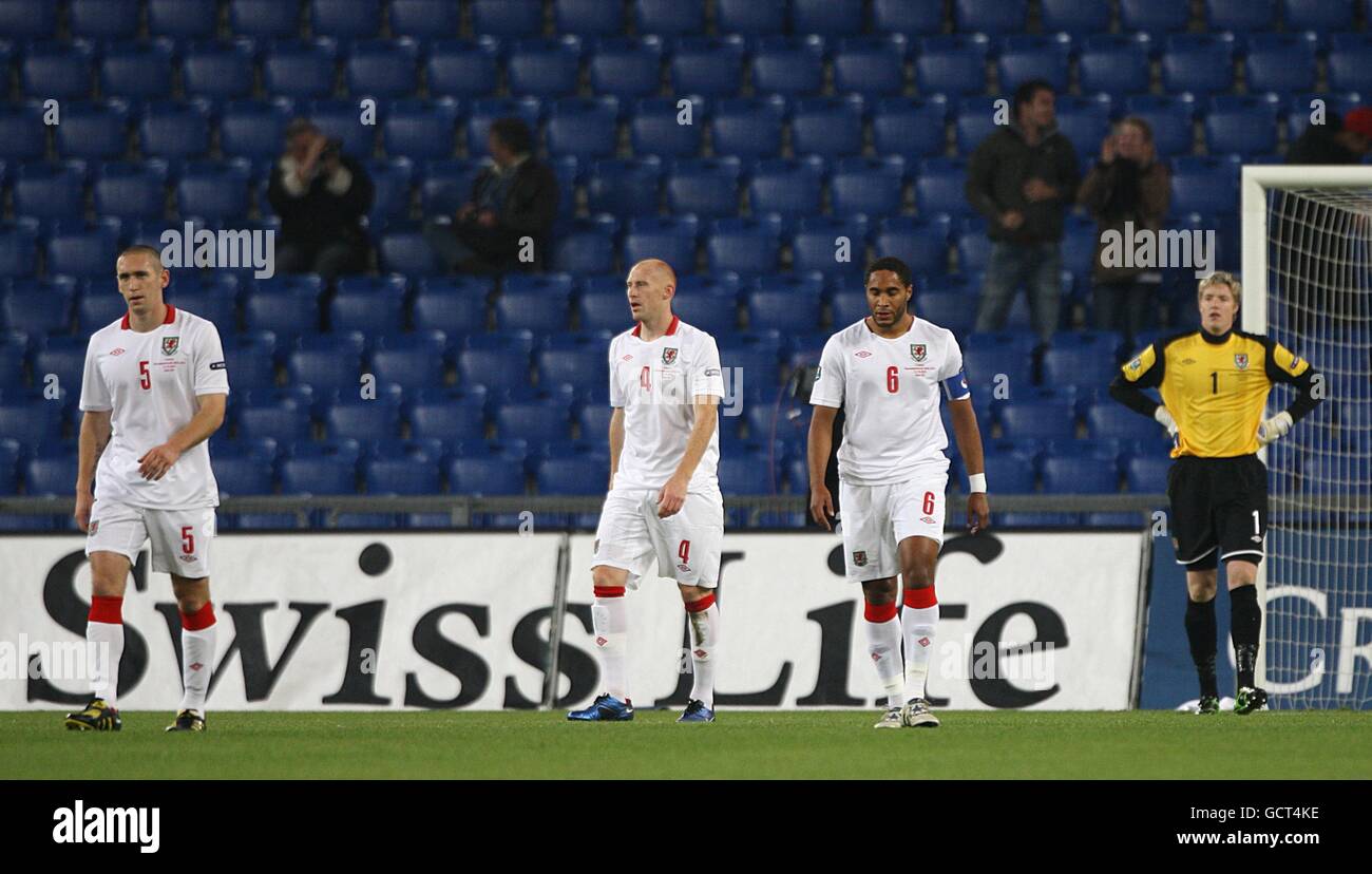 Wales' Andrew Crofts (left), James Colins (2nd left), Ashley Williams and goalkeeper Wayne Hennessey look dejected after Switzerland score their first goal of the game Stock Photo