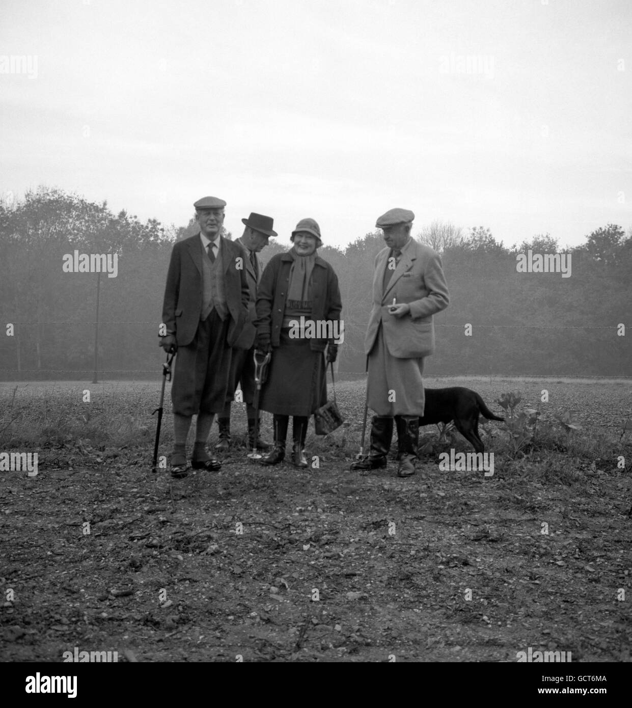 Prime Minister Harold Macmillan (left), wearing plus-fours and spats, seems to be sharing a light-hearted joke with Sir Thomas (right) and Lady Sopwith while out shooting at Broadlands, Romsey, Hampshire. Stock Photo