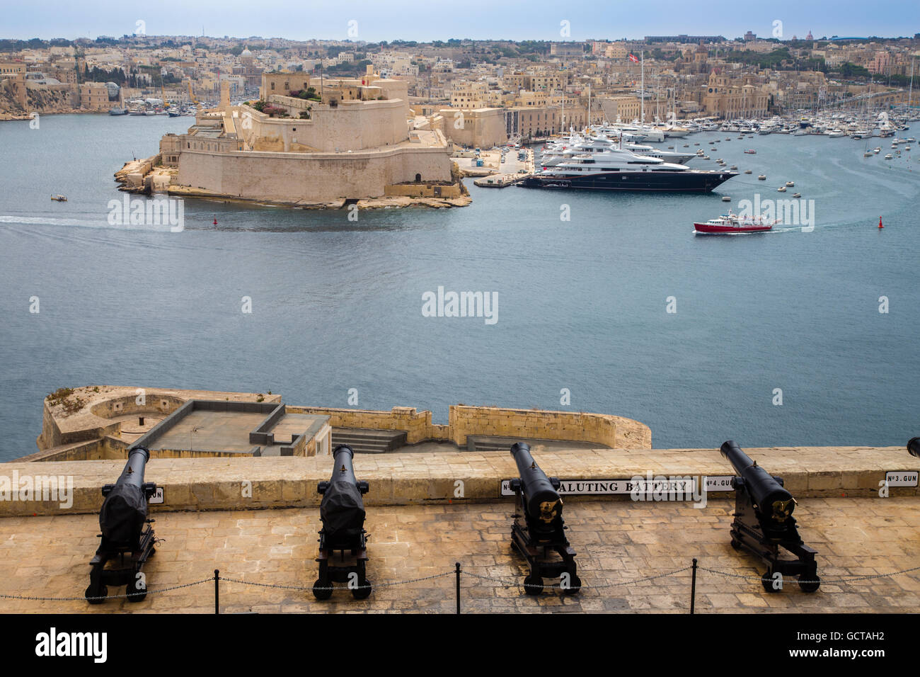 View from Valetta Upper Barrakka gardens over the Saluting Battery cannons to the Grand Harbour and Senglea Three Cities area, M Stock Photo