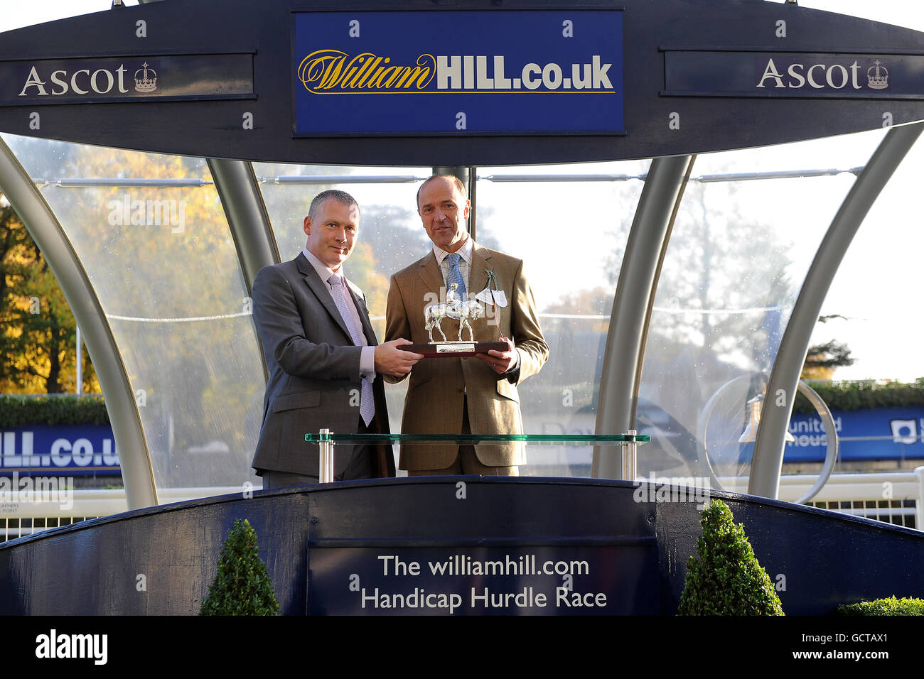 Horse Racing - United House Day: Charity Firework Spectacular - Ascot. Representatives of Tocca Ferro receive the trophy for victory in the williamhill.com Handicap Hurdle Stock Photo