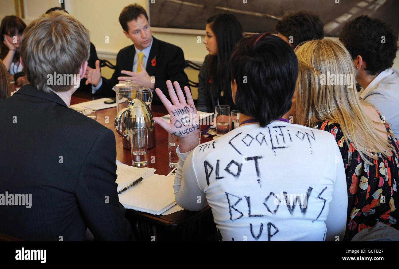 Clare Solomon (white top), President of the University of London Student Union expresses her opinions about the government's education policy on tuition fees on her clothing during a meeting with the Deputy Prime Minister Nick Clegg at his office in London. Stock Photo