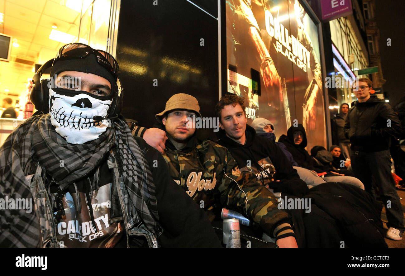 (Left to right) Dwane Martin, Desmond Botes, and Tony Hart who started to queue at 4pm yesterday afternoon, head a large group of computer game fans as they queue up to buy the new 'Call of Duty: Black Ops' game, outside the Game store in Oxford Street, central London. Stock Photo