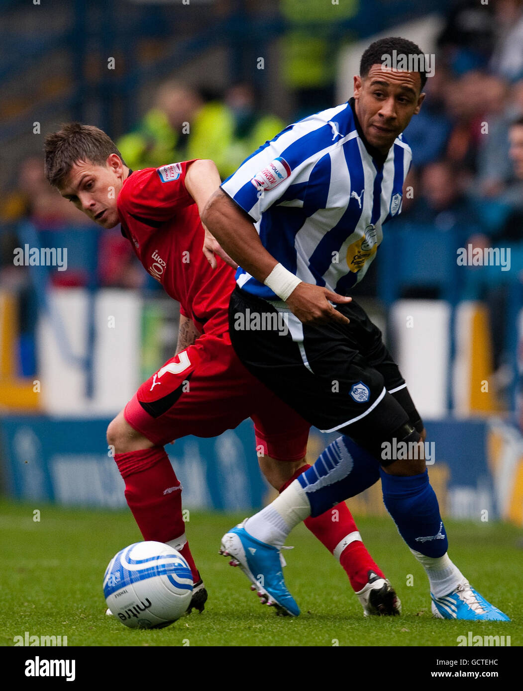 Sheffield Wednesday's Jon Otsemobor and Leyton Orient's Dean Cox (left) battle for the ball during the npower League One match at Hillsborough, Sheffield. Stock Photo